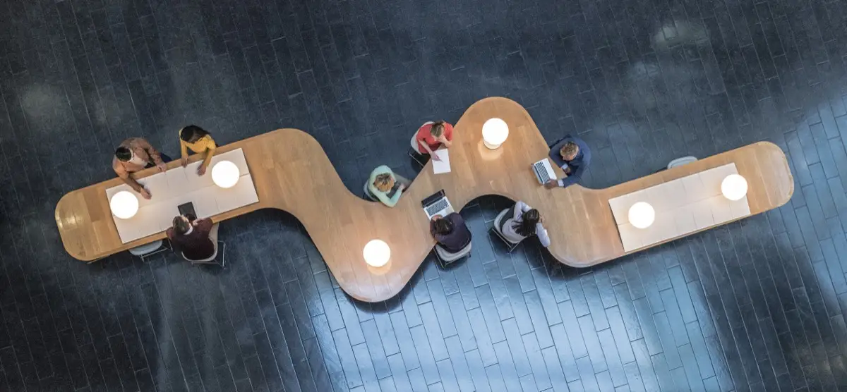 People working on a modern shaped table